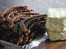 Best Barfi Sweets For Festival Celebration in Chennai A bundle of traditional jeerani sticks, neatly arranged next to a woven palm leaf box, exuding rustic charm.