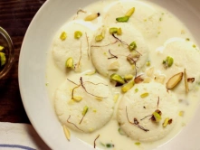 Top Authentic Indian Ras-Malai Sweets For Diwali Celebration Delicious ras malai soft cheese dumplings soaked in creamy milk, garnished with pistachios.