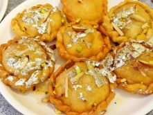 Best Diwali Delight Chandrakala Sweet in Chennai Price A chandrakala dessert, featuring golden pastries filled with sweet khoya and nuts, topped with delights.