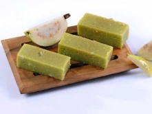 Best Guava Sweet Retailers Products in Chennai A wooden board holds the resting guava-mysurpa, highlighting its fresh appearance and organic appeal