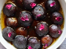 Best Kala Jamun Sweet Manufacturers Latest Price in Chennai A bowl containing vibrant black kala-jamun balls, showcasing a beautiful and colorful display.
